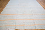 Hand-woven vintage rag rug featuring variegated ivory texture and warm peach stripes.