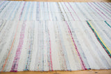 Vintage hand woven rag rug with textured ivory, pastel, peach, and charcoal striped pattern.