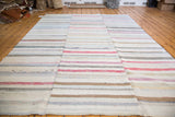 Hand-woven linen rag rug with pastel and neutral striped texture.