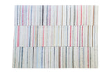Vintage hand woven rag rug with pastel, ivory, charcoal striped plaid effect.