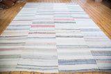 Vintage rag rug with hand woven striped blocks in pastel and neutral tones.