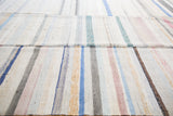 Vintage hand-woven rag rug with ivory, pastel, and charcoal vertical stripes.