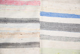 Hand woven rag rug texture with pastel and neutral linen stripes.