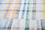 Hand woven vintage rag rug featuring unique plaid design in pastel and neutral linen.
