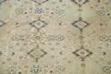 Vintage Turkish carpet's allover repeating design with ivory, beige, and soft grey botanical motifs.