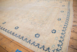 Khotan vintage carpet corner, deep blue border, and worn ivory medallion patterns.