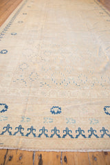 Vintage Khotan carpet ivory end border with stylized dark blue motifs and fringe.