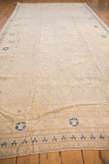 Khotan style carpet border in ivory and blue, showcasing its worn aesthetic.