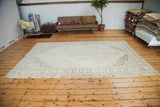 Vintage Oushak carpet with ivory field, center medallion, and soft beige patterns, 7'2