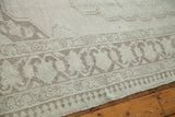 Stylized border motifs and ivory field with soft beiges on a Vintage Oushak rug.