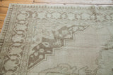 Vintage Oushak carpet's ivory field with platinum tones and soft beige curvilinear border.