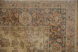 Distressed texture and muted saffron gold field on a vintage Turkish Sparta rug corner.