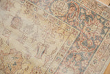 Distressed texture and worn pattern details on the saffron yellow Turkish Sparta carpet.