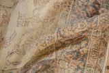 Distressed texture and worn saffron gold patterns on the vintage Sparta carpet.