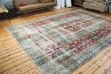 Vintage Oushak rug's decorative distressed texture, whimsical burgundy, and deep green patterns.