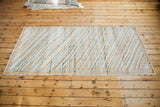 Distressed Oushak runner, its diagonal box pattern in ivory, orange, and grey charcoal.
