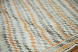 Textured ivory, orange, charcoal diagonal box pattern of a distressed Oushak runner.
