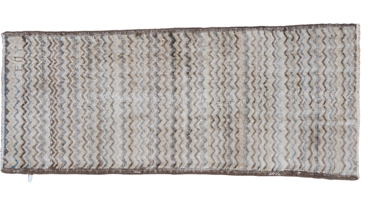 Distressed vintage Oushak Tulu runner with a chevron pattern in ivory, charcoal, and slate blue.