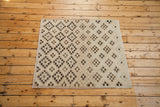 Distressed Sparta Oushak square rug featuring ivory, beige, chocolate, black square and diamond motifs.