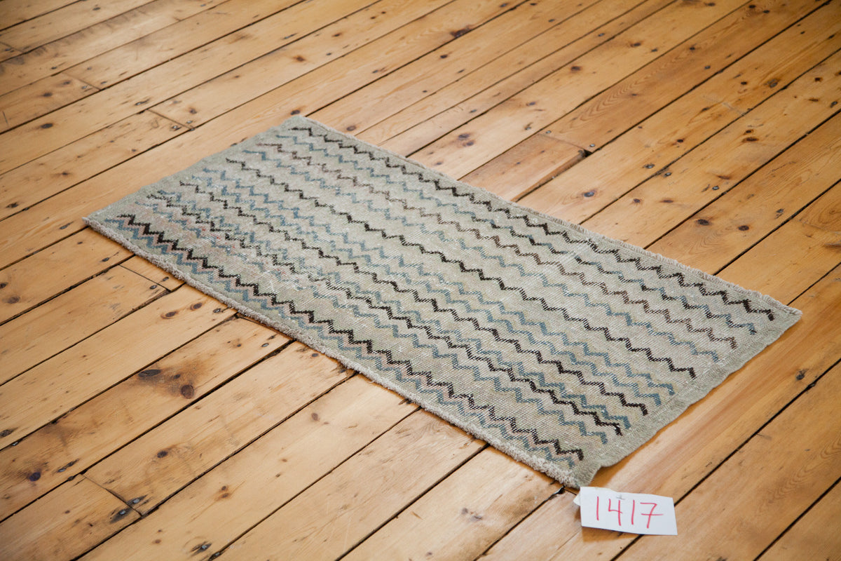 Vintage Oushak runner with distressed chevron pattern in ivory, silver, charcoal, and slate blue.