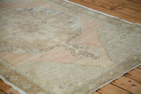 Decorative distressed Oushak texture with faded grapefruit melon, bronze, and sea foam tones.