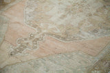 Vintage distressed Oushak rug with low pile and faded grapefruit melon pattern.
