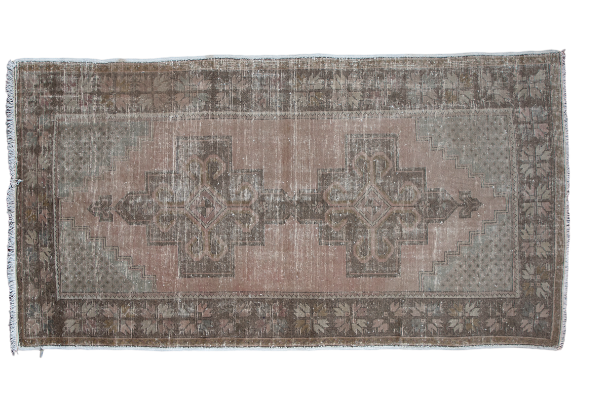 Distressed vintage Turkish Oushak rug with double medallion, peach field, and charcoal geometric border.