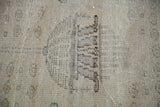 Distressed texture of vintage Oushak rug showing faded silver, platinum, and orange.