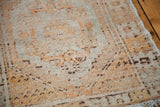 Textured, distressed pile of a vintage Oushak rug with soft platinum and faded orange.