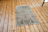 Distressed Oushak rug texture with muted germinating flower design.