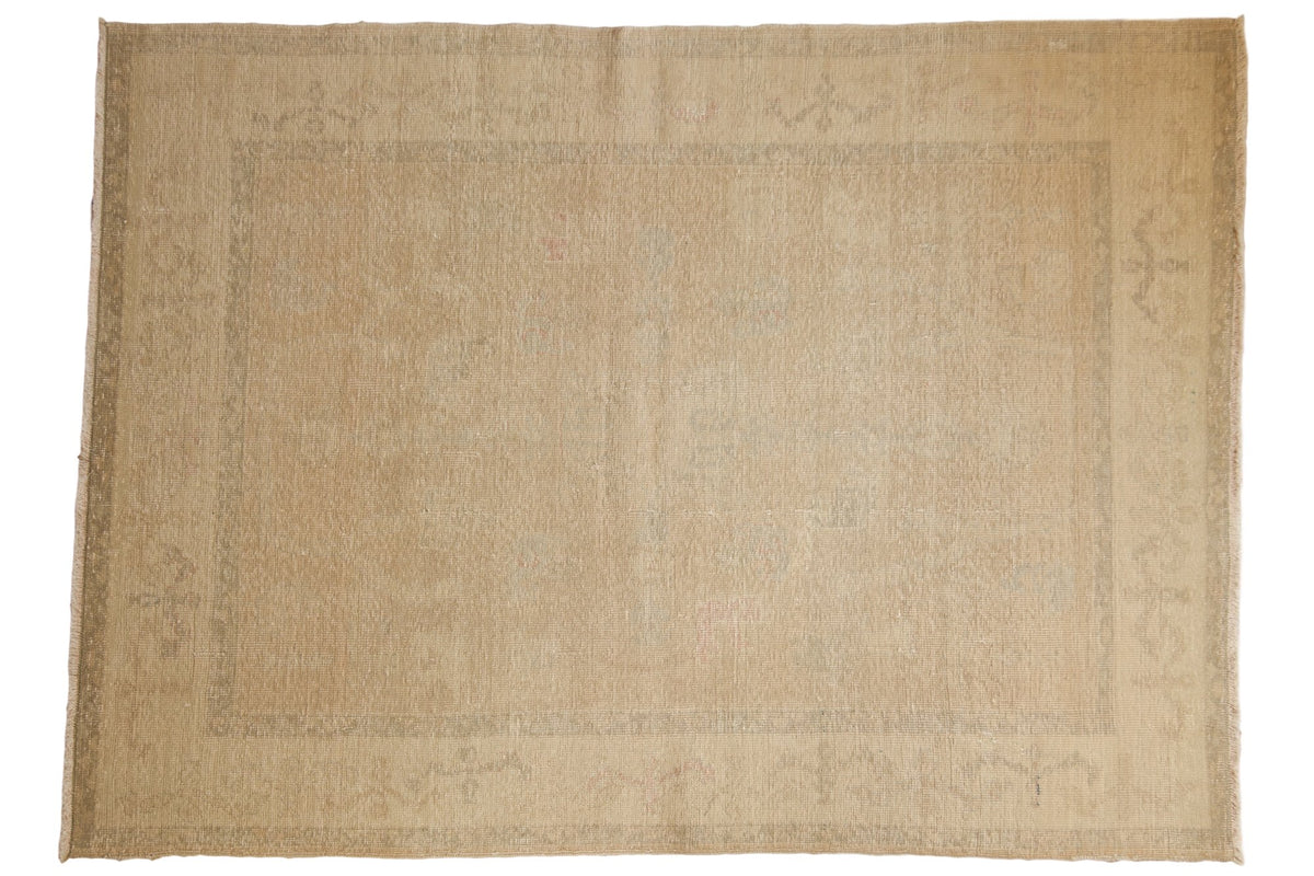 Distressed Oushak carpet, soft beige gold with vintage worn aesthetic and light rose tones, 5'8" x 7'9".