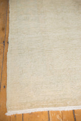 Worn texture of a light ivory and pale grey-blue distressed Oushak carpet.