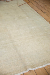 Faded pale grey-blue and ivory texture on a distressed vintage Oushak carpet.
