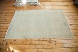 Soft beige gold vintage Oushak carpet showing its worn aesthetic and rose shade.