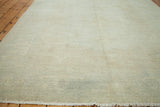 Soft beige gold distressed Oushak carpet pile with a fringed edge.