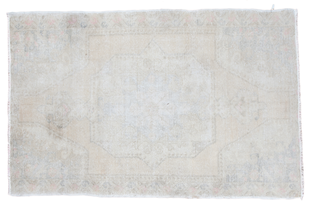 Distressed Oushak rug in lemony beige, ivory, rose, platinum with medallion pattern.