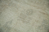 Distressed Oushak carpet pile showing even wear in pale silver and faded sage.