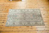 Distressed texture and blanched sand hues on a vintage Turkish Oushak rug.