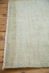 Worn aesthetic and subtle lemon ivory shades on a distressed Oushak rug's pile and fringe.