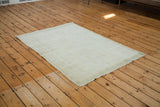 Distressed vintage Oushak rug displaying its worn aesthetic and lemon ivory shade, 4x6.