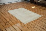 Worn texture and muted rose ivory shades of the distressed Oushak rug.