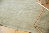 Textural view of distressed vintage Oushak rug in pale earth tones.