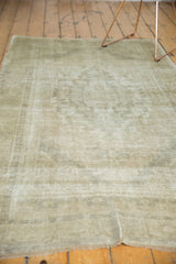 Pale earth tone vintage Oushak rug pile with subtle distressed texture and fringe.