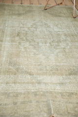Distressed vintage Oushak rug pile showcasing pale earth tones, beige, grey, and silver ivory.