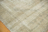 Subtle pale earth tones and distressed texture on a vintage Oushak rug.