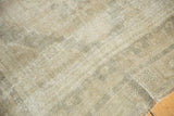 Decorative distressed Oushak rug texture in soft beige, grey, and ivory tones.