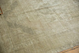 Soft, distressed Oushak pile in pale beige, silver ivory, and subtle grey hues.