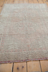 Worn texture and faded brick rose geometric patterns on distressed Oushak rug.
