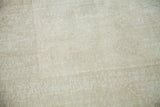 Distressed, faded pile texture with pale ivory and platinum tones.