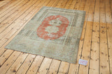 Intricate double medallion motif on a vintage Oushak rug with brick orange abrash.
